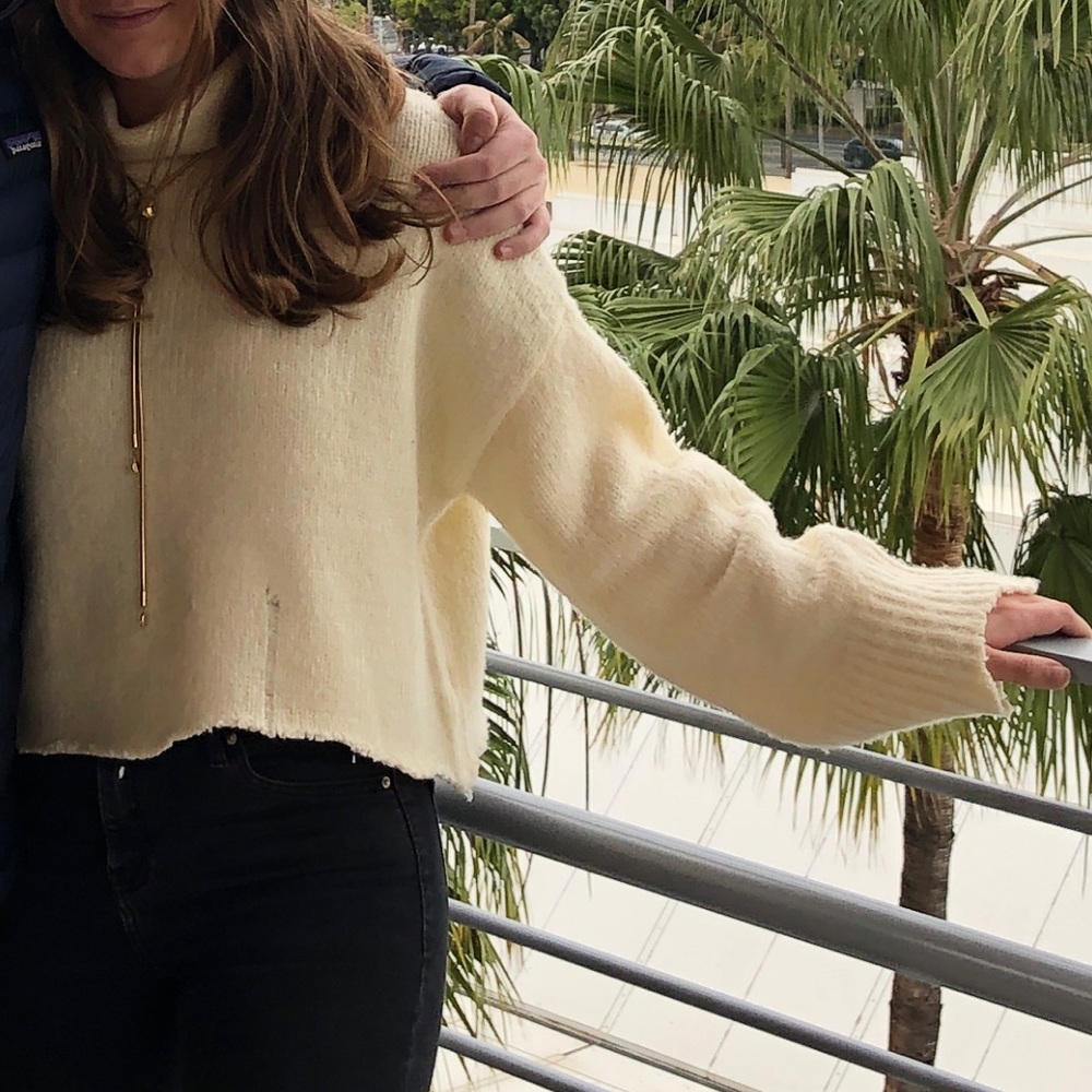 Distressed cream turtleneck